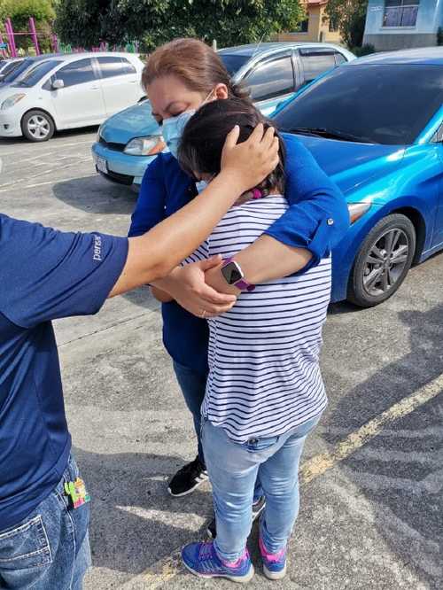 Our staff pray with Isabella on her last day at Oasis